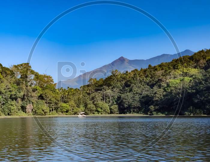 Amazing View Of Lake With Greens And Hills Under The Blue Sky