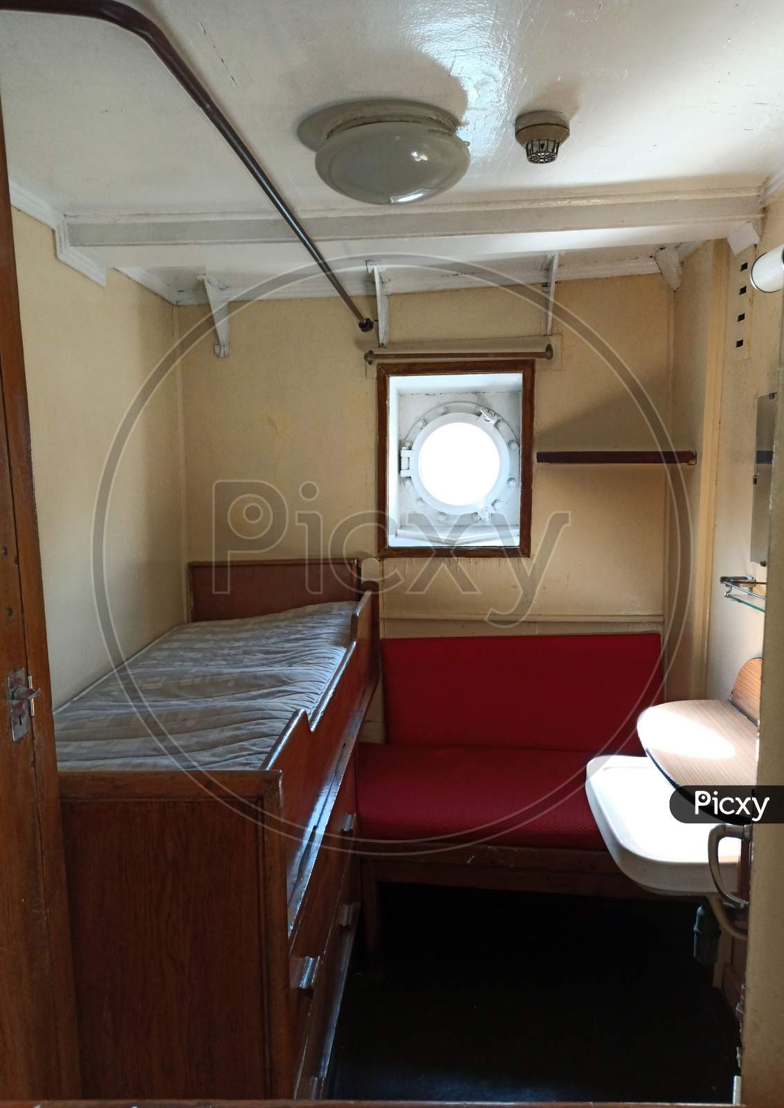 Gdansk, Poland - May 07, 2020: Cabin With Congested Sitting And Sleeping Area With Round Window Inside The Ss Soldek Ship, Part Of The Polish Maritime Museum In Gdansk Near Baltic Sea, Europe