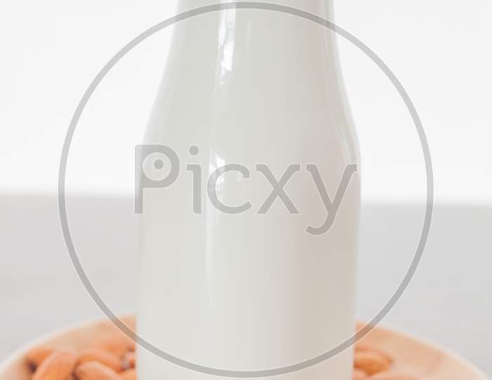 Almond Nuts On Wooden Plate With Milk