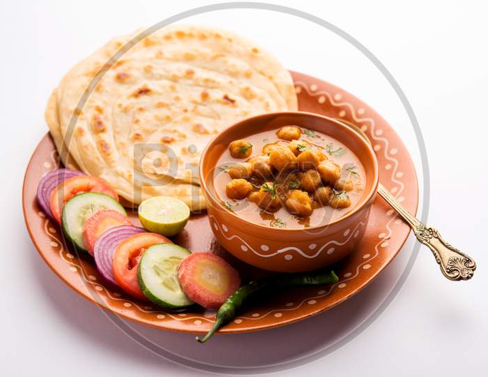 Chole Masala Or Chickpea Curry Served With Laccha Paratha And Green Salad. Indian Food
