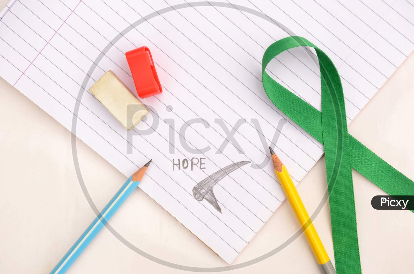 Pencil With Writing Hope Mental Health Awareness Concept Not Book ,Green Ribbon,Eraser,Sharpener On The White Background.