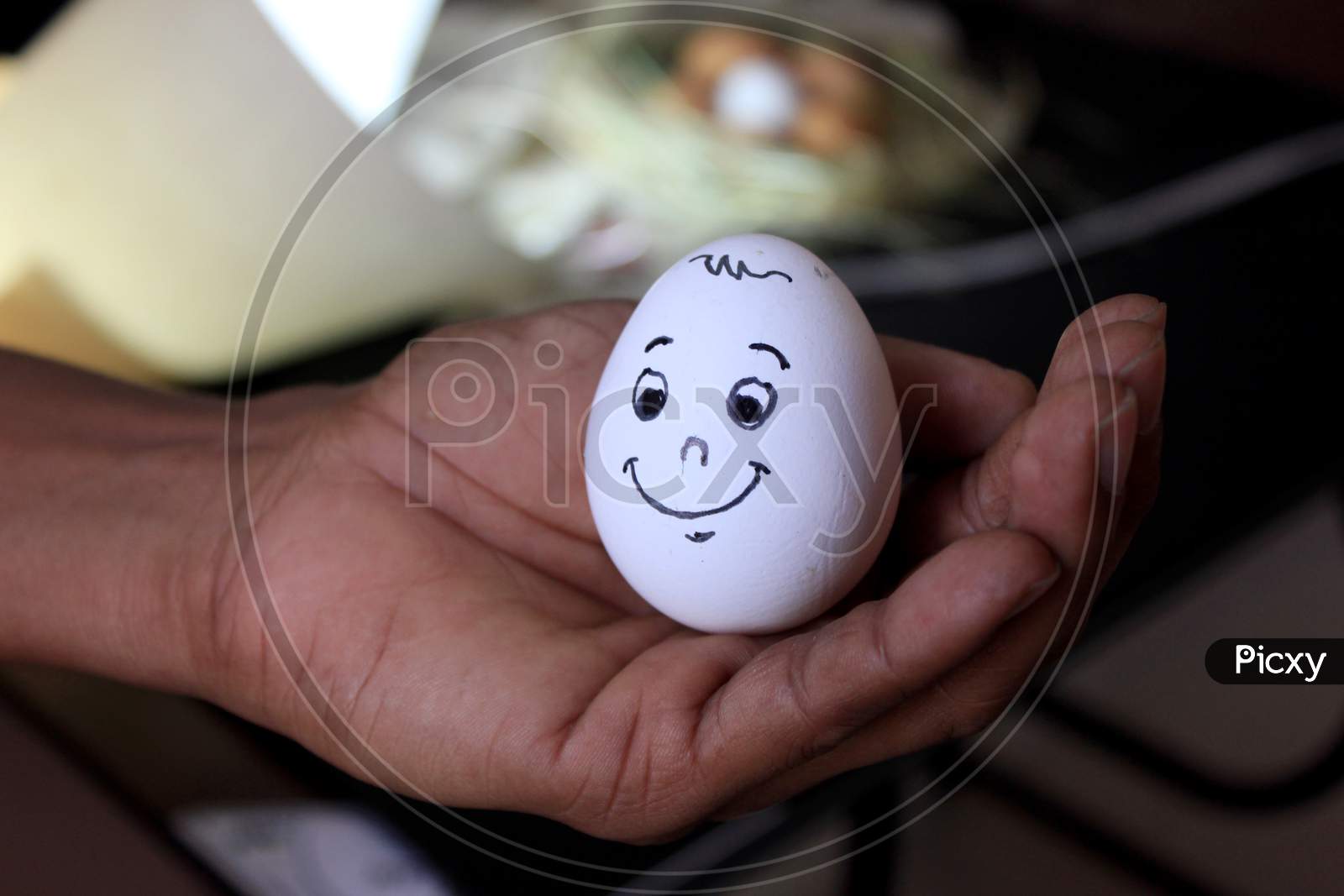 Smiling Egg On Top Of The Palm