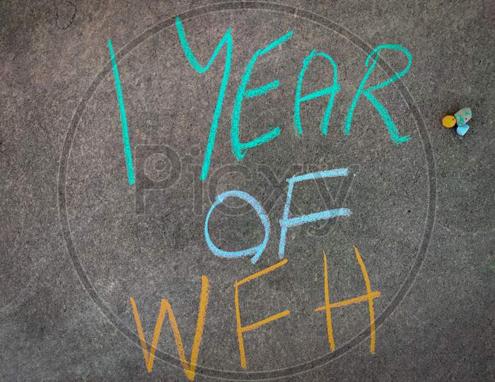 The Inscription Text On The Grey Board, 1 Year Of Wfh (Work From Home). Using Color Chalk Pieces.