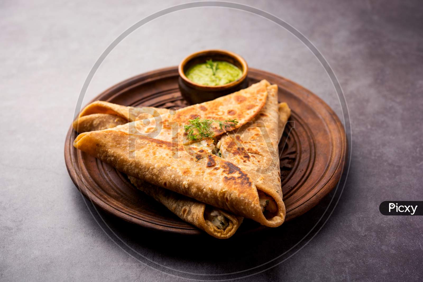 Indian Food Triangle Shape Paratha Wrap Served With Chutney