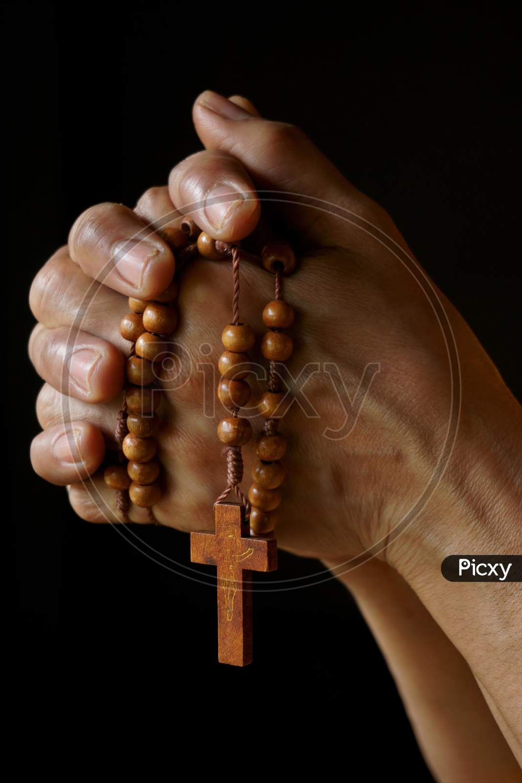 Praying hands of an old Indian Catholic woman