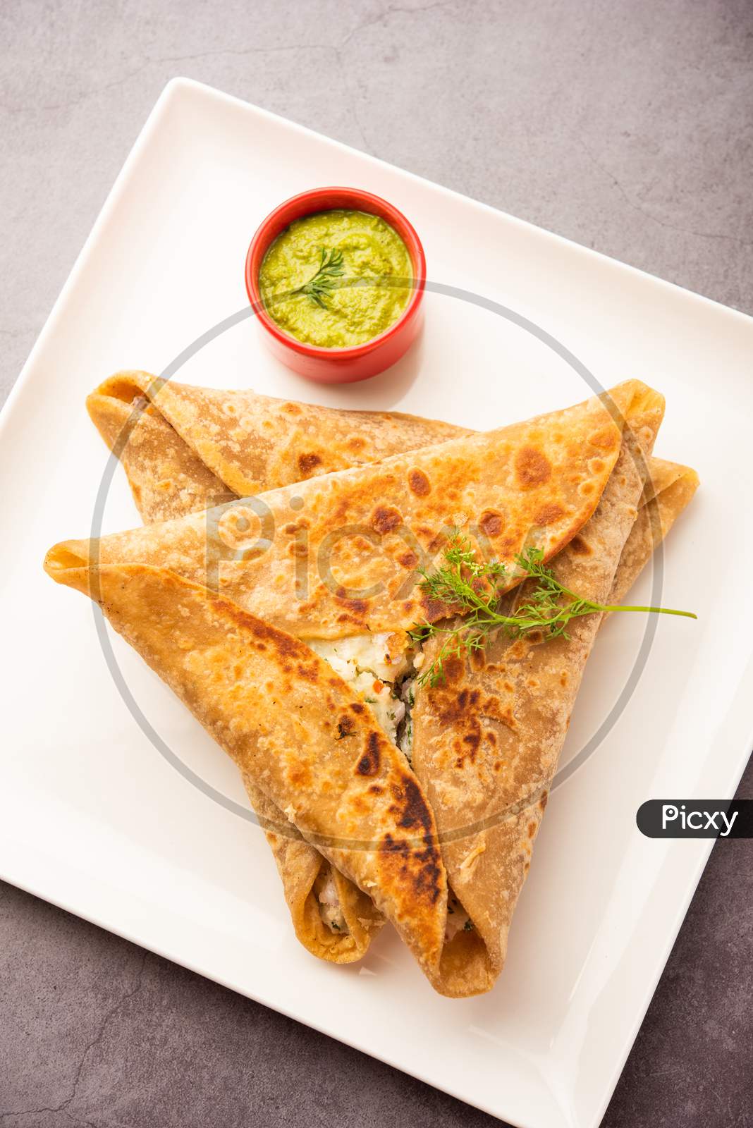 Indian Food Triangle Shape Paratha Wrap Served With Chutney