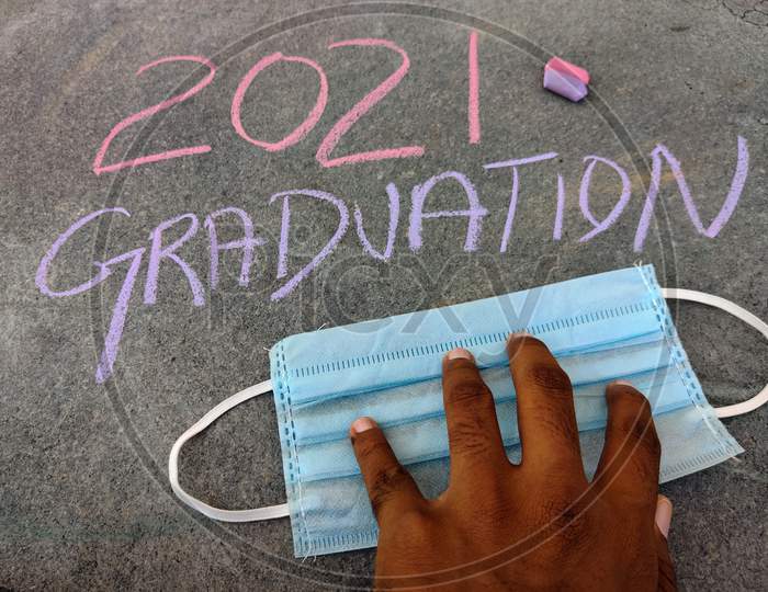 The Inscription Text On The Grey Board, 2021 Graduation Using Color Chalk Pieces And South Indian Male Hands On Surgical Mask