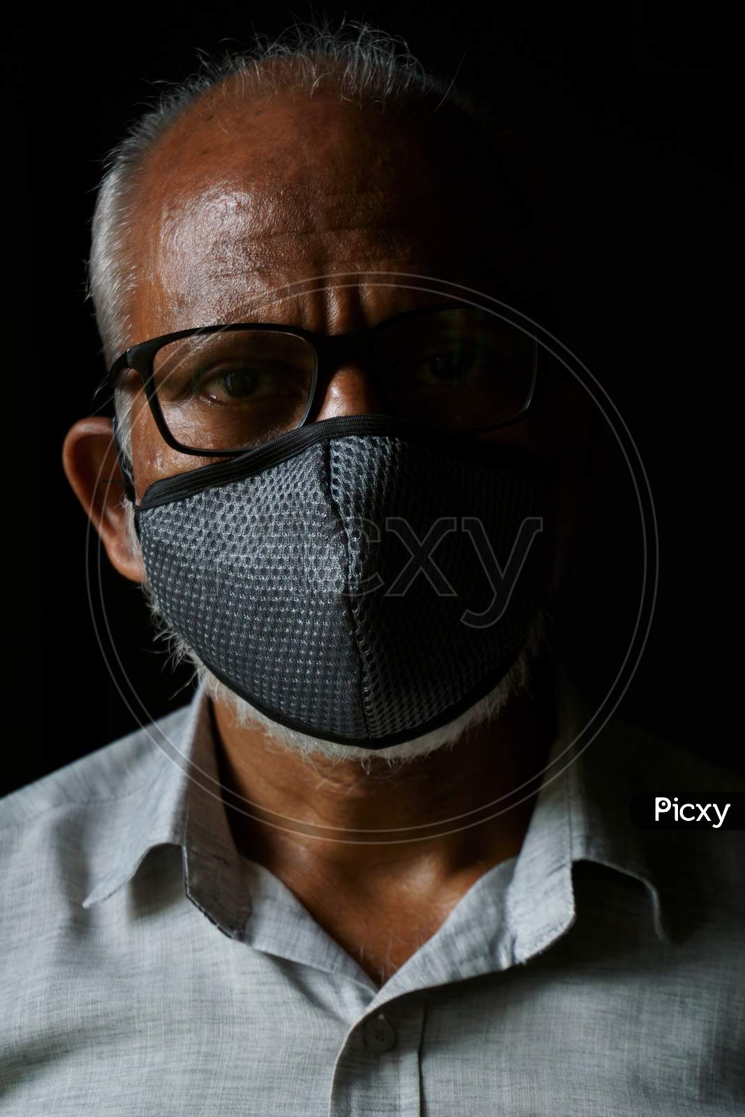 Portrait of 60-year-old Indian man wearing mask