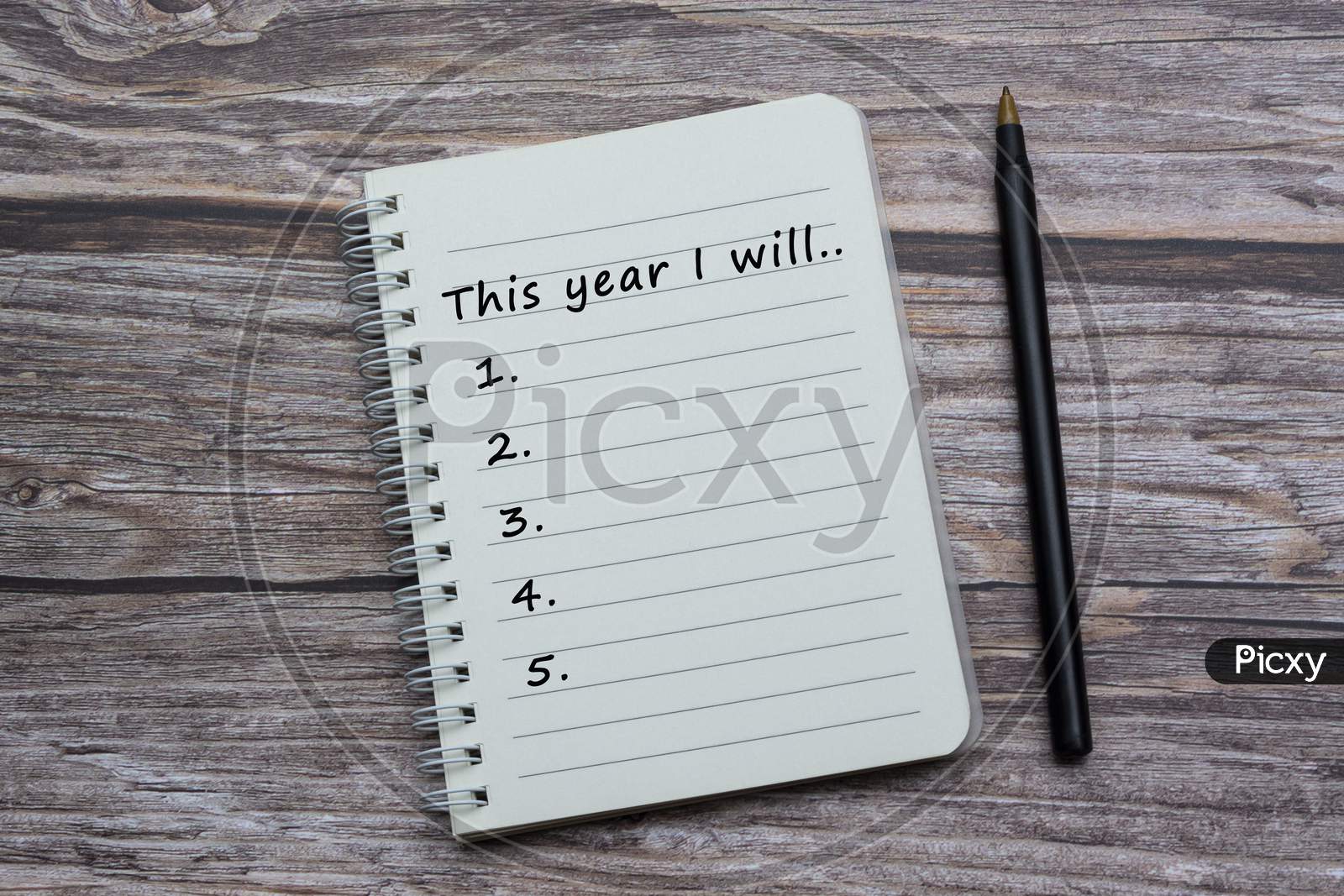 Text On Notebook With Pen On Wooden Desk - This Year I Will