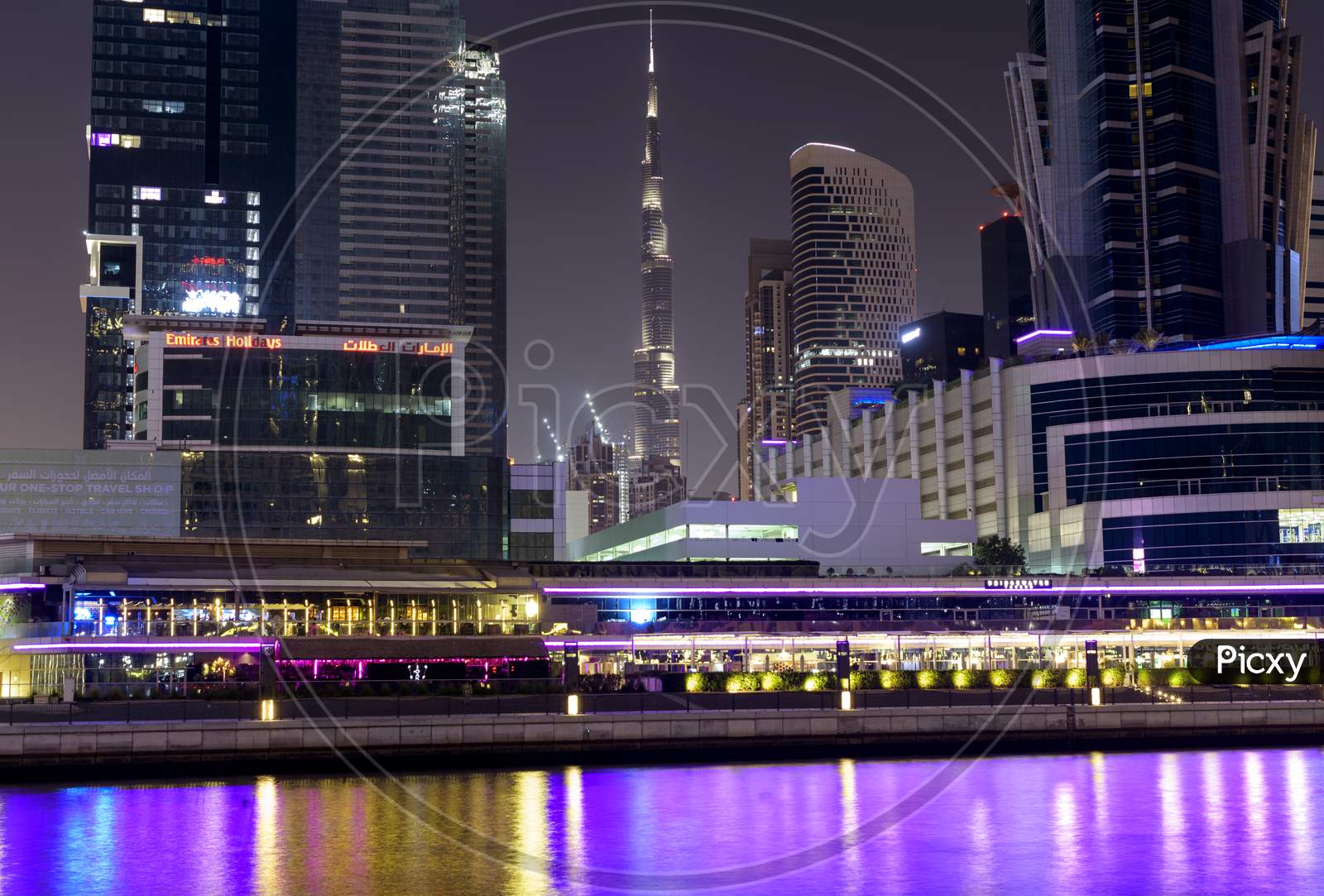 Dubai, Uae 6Th Nov 2020 -View Of The Burj Khalifa Surrounded With Buildings And Hotels Facing The Colorful Illuminated Dubai Canal Boardwalk Waterfall In Dubai,United Arab Emirates, Middle East