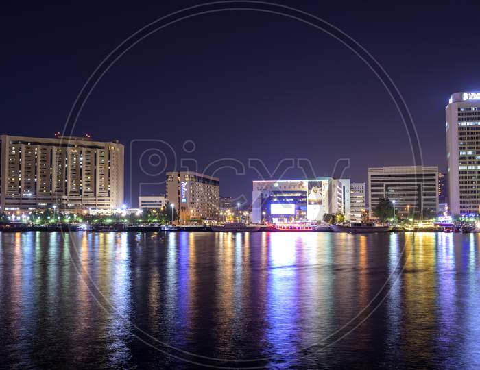 Dec 17 2020, Al Seef Village, Dubai. Panoramic View Of The Illuminated Sky Scrappers,Hotels And Buildings Showing Beautiful Reflections In Water Captured At The Al Seef, Dubai ,Uae.
