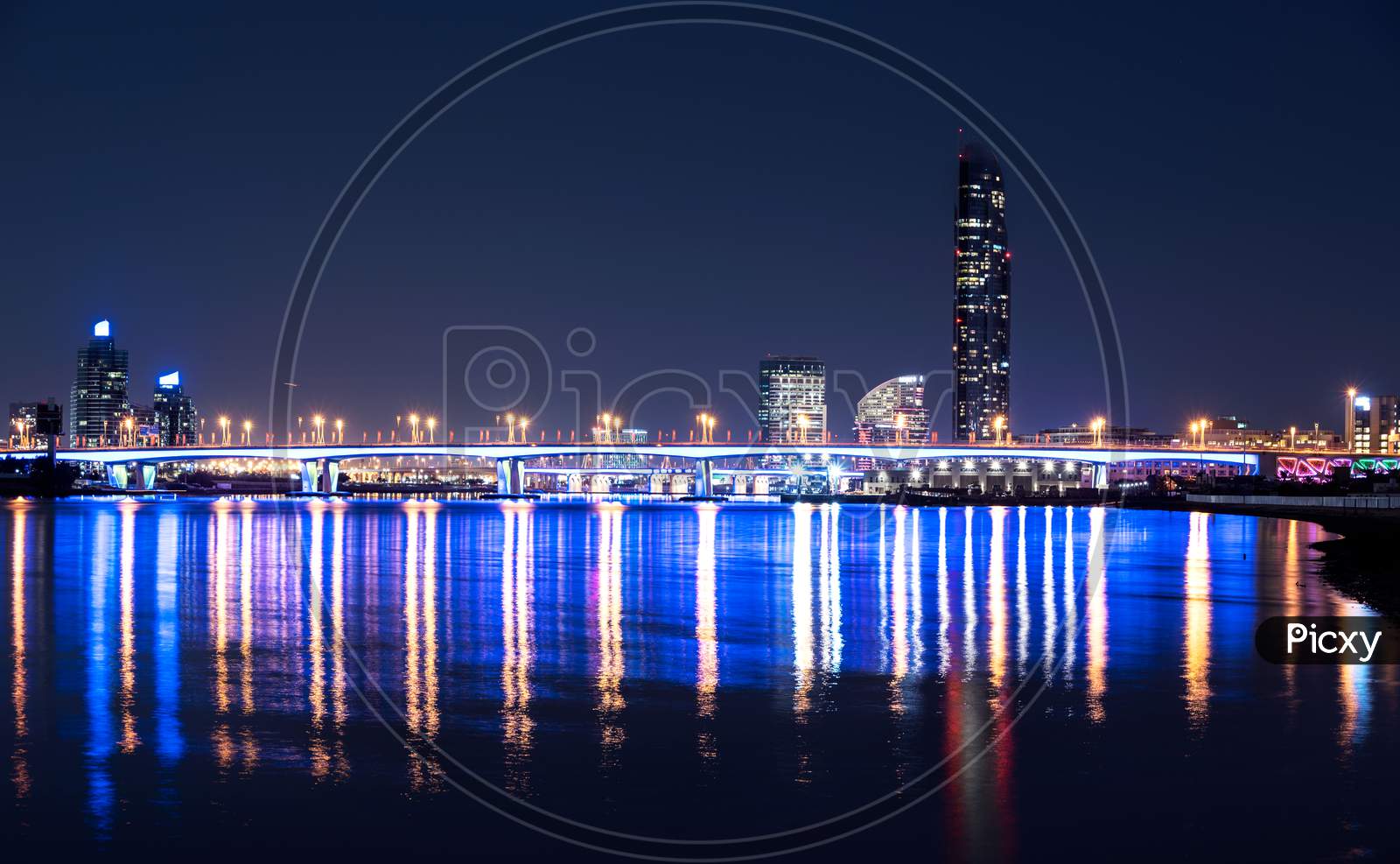 Dec 29Th 2020. Beautiful Night View Of The Illuminated Garhoud Bridge Across The Water With Reflections, Surrounded By The Majestic Sky Scrapers And Hotels Captured From The Creek Park Dubai , Uae.