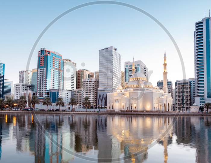 Jan 8Th 2021, Sharjah, Uae. Panoramic View Of The Beautifully Illuminated Al Noor Mosque During The Early Sunrise Hours Showing Reflections In Water Captured From The Al Noor Island Sharjah, Uae.