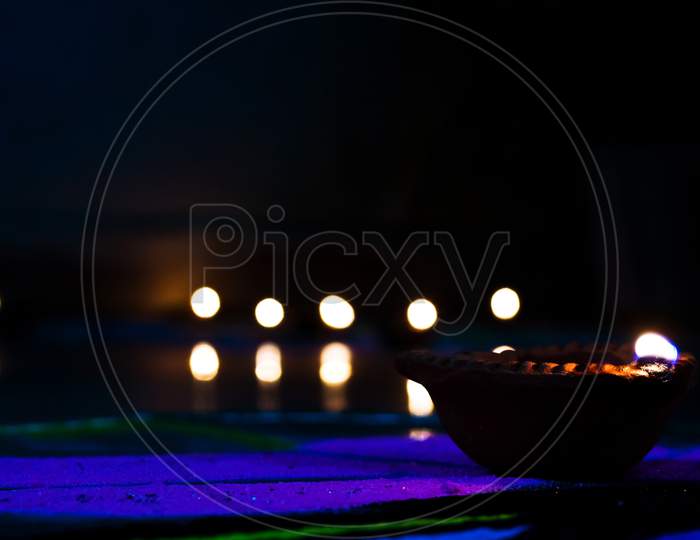 The Diwali Diya at night with black background and Rangoli