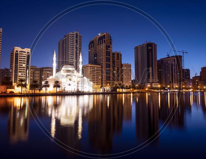 Jan 8Th 2021, Sharjah, Uae. Panoramic View Of The Beautifully Illuminated Al Noor Mosque During The Early Sunrise Hours Showing Reflections In Water Captured From The Al Noor Island Sharjah, Uae.