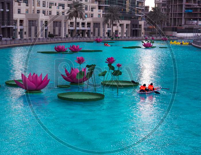 Jan 7Th 2021, Dubai, Uae. Tourists Riding The Boats In The Beautiful Lotus Flower Pool At The Recreational Boulevard Area Of The Burj Park, Dubai,Uae.