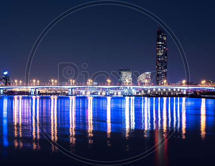 Dec 29Th 2020. Beautiful Night View Of The Illuminated Garhoud Bridge Across The Water With Reflections, Surrounded By The Majestic Sky Scrapers And Hotels Captured From The Creek Park Dubai , Uae.