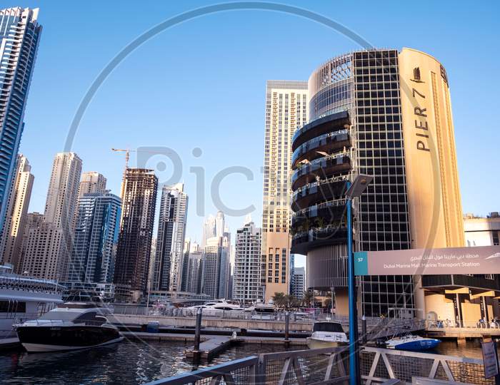 Dec 28, 2020 ,Dubai,Uae.Panoramic View Of The Beautiful Pier 7 Restaurants In Dubai Marina Luxury Touristic District With Marina Mall And Canal With Yachts On Background. Dubai Marina.