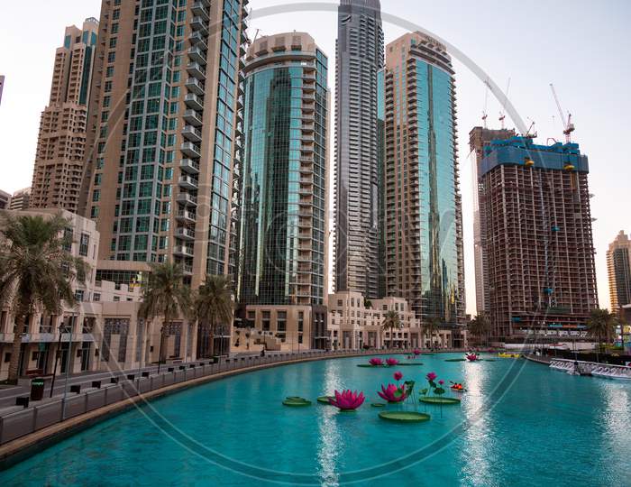 Jan 7Th 2021, Dubai, Uae. Tourists Riding The Boats In The Beautiful Lotus Flower Pool At The Recreational Boulevard Area Of The Burj Park, Dubai,Uae.
