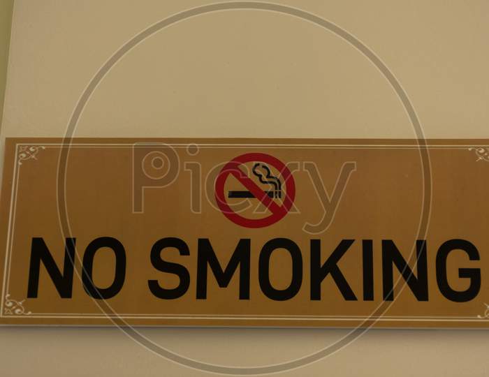 A No Smoking Sign Board On Wall