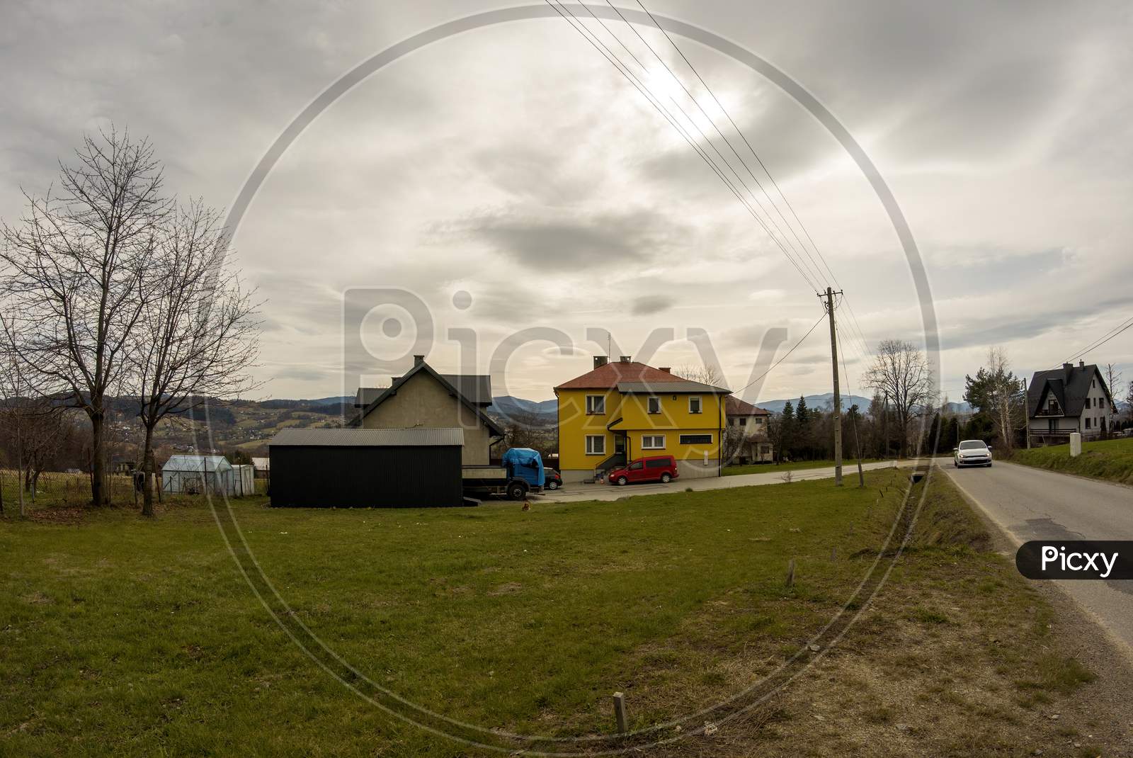 Limanowa, South Poland - April 01, 2021: View Of Houses Showing Country Life In Polish Village Located In Lysa Gora Beskid Wyspowy Polish Mountains