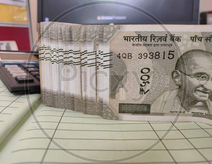 Indian Currency Rupee 500 Bundle Kept On Cashbook With Calculator