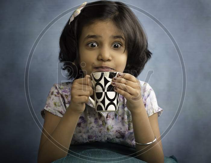 Little girl with coffee mag