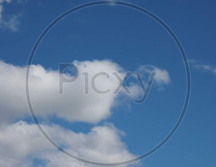 Dark Blue Sky With Clouds Background