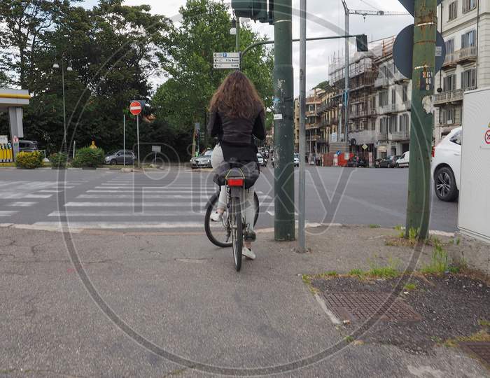 Turin, Italy - Circa May 2019: Woman On A Bike At Traffic Light Zebra Crossing