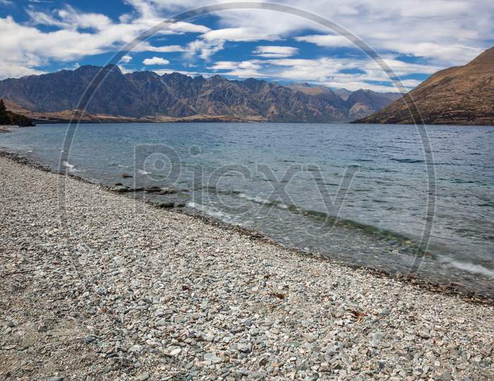 Queenstown, Otago, New Zealand - February 17 : View Of The Remarkables Mountain Range In New Zealand On February 17, 2012. Two Unidentified People