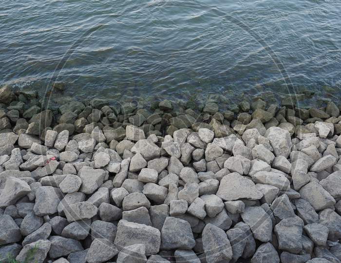 Blue Water Surface With Rocks Background