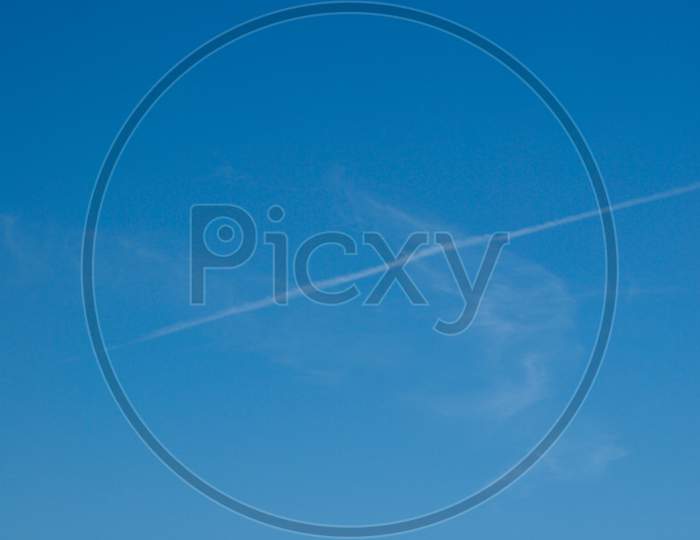 Plane Trail Over Blue Sky
