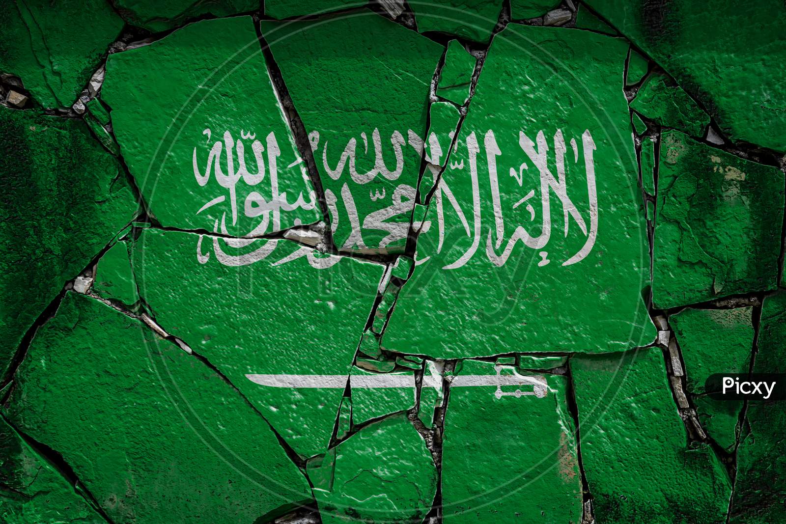 National Flag Of Saudi Arabia Depicting In Paint Colors On An Old Stone Wall. Flag  Banner On Broken  Wall Background.