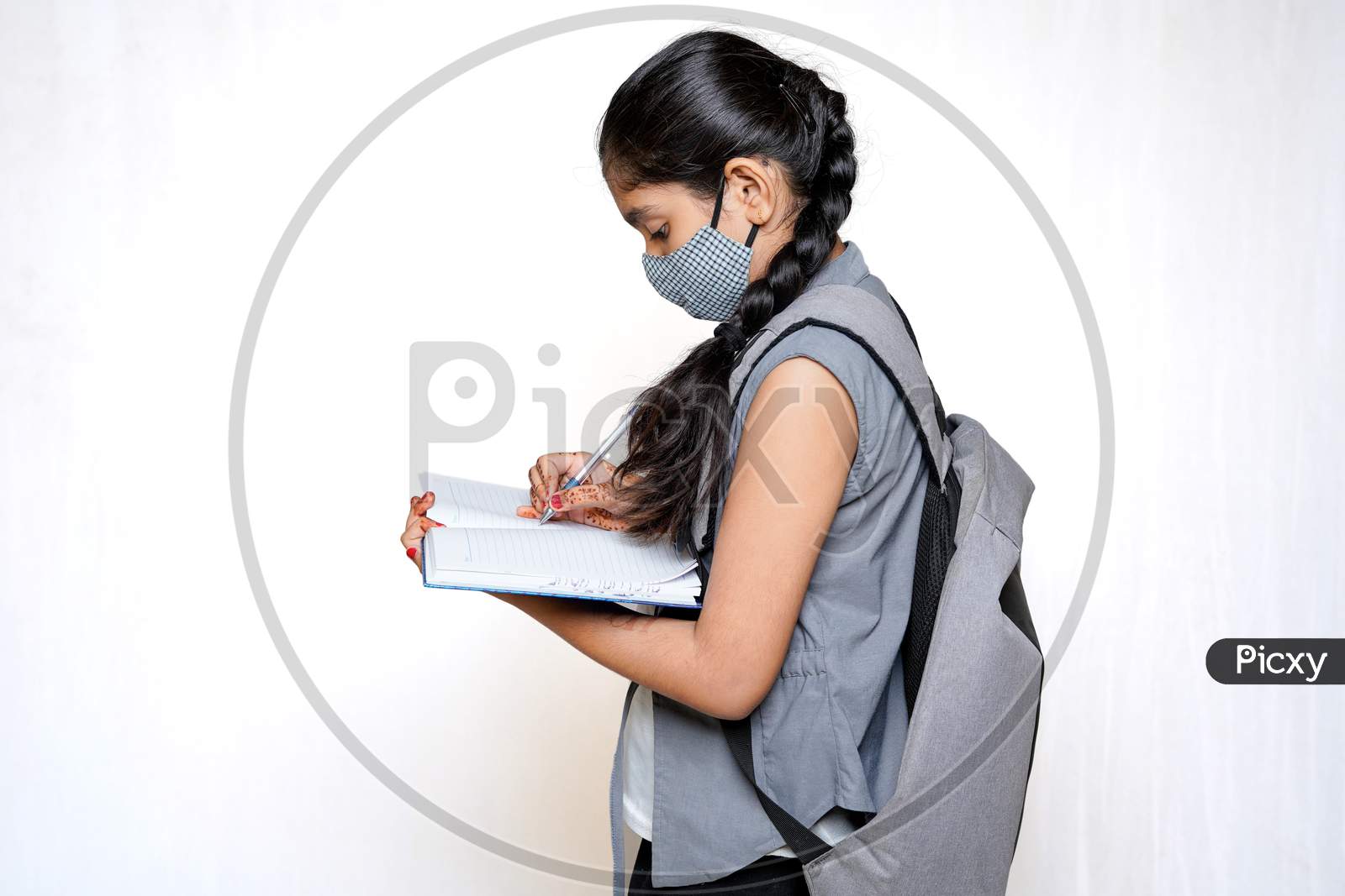 Indian Girl Writing On Notebook