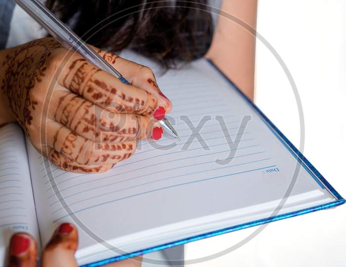 Indian Girl Writing On Notebook