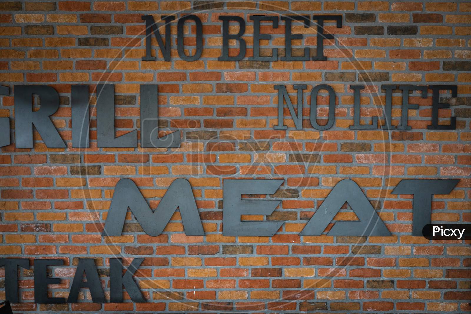 Brick Wall With The Words "No Beef, No Life, Grill, Meat, Steak". The Urge To Eat Meat