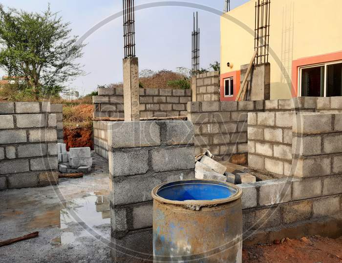 Closeup Of New Residential House Cement Bricks Wall Construction With Columns In A Nature Background