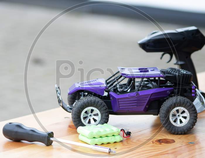 Image of Off road rc car with remote control and battery ready to race