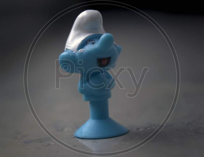 Krakow, Poland - May 01, 2021: Extreme Close Up Macro Shot Of A Tiny Cute Blue Smurf Rubber Toy Figure A Fictional Character From The Smurfs. Selective Focus. Shallow Depth Of Field