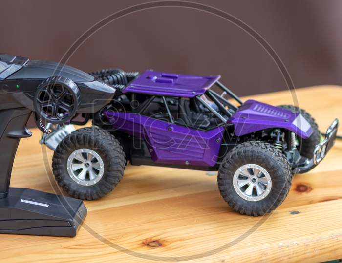 Image of Off road rc car with remote control and battery ready to race