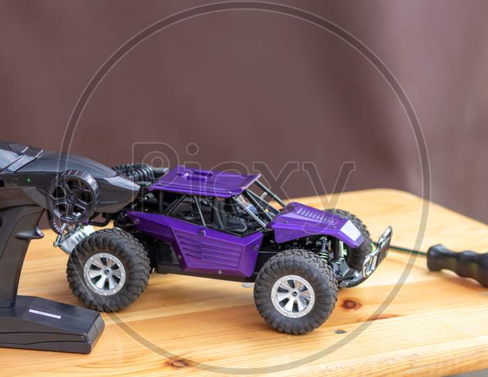 Image of Off road rc car with remote control and battery ready to race