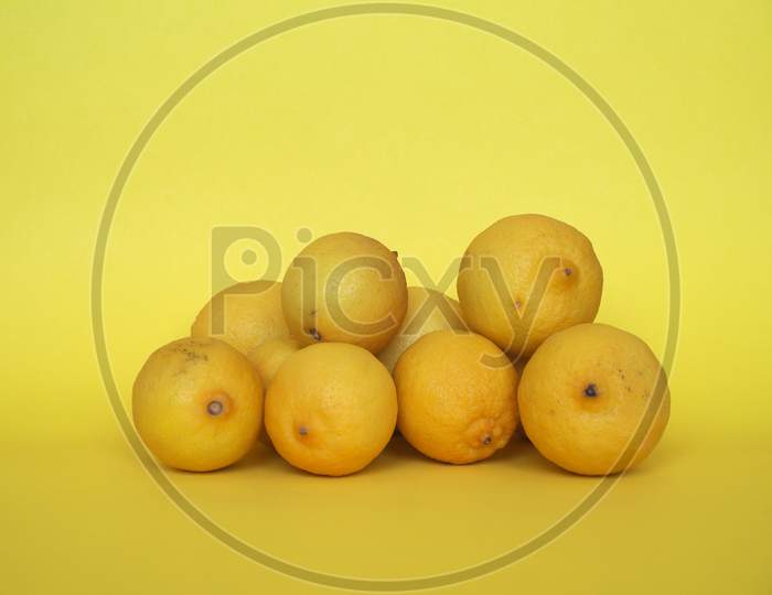 Lemon Fruits Over Yellow Background