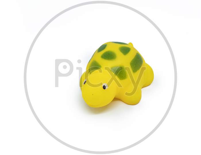 Yellow Colored Plastic Tortoise Toy Isolated On White Background