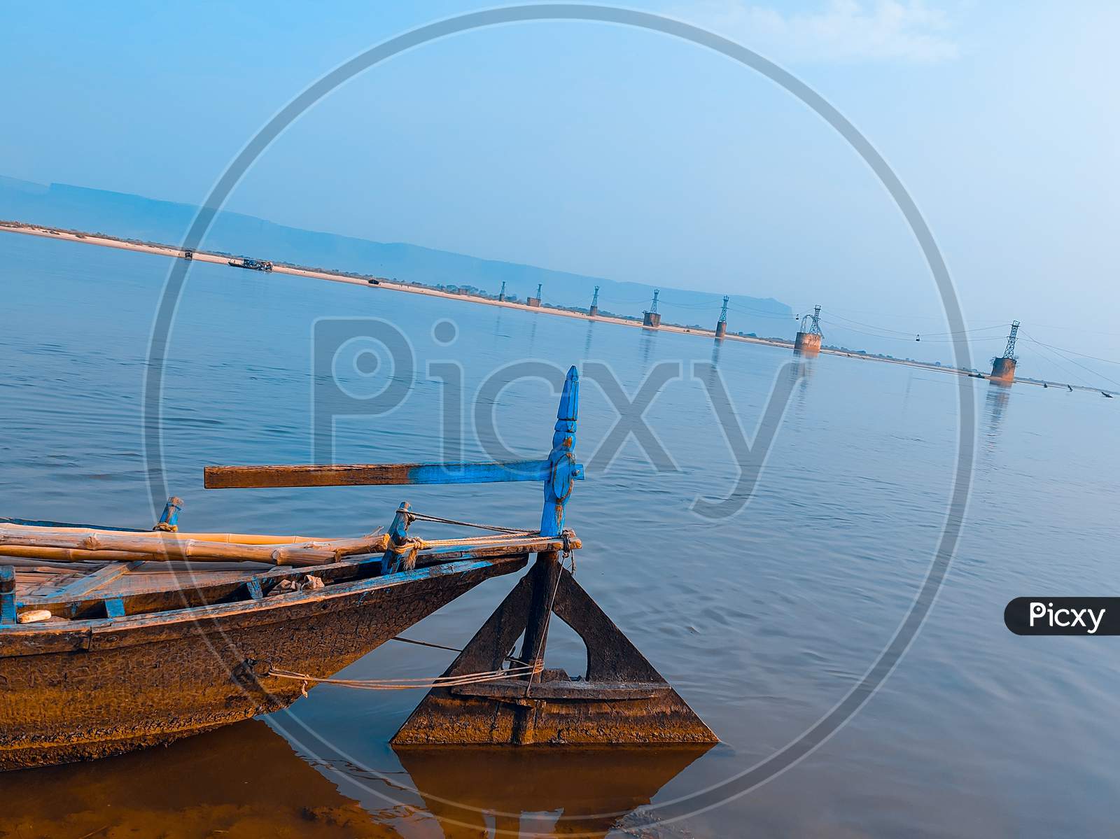 Boat In River With Light Blue Sky Background.