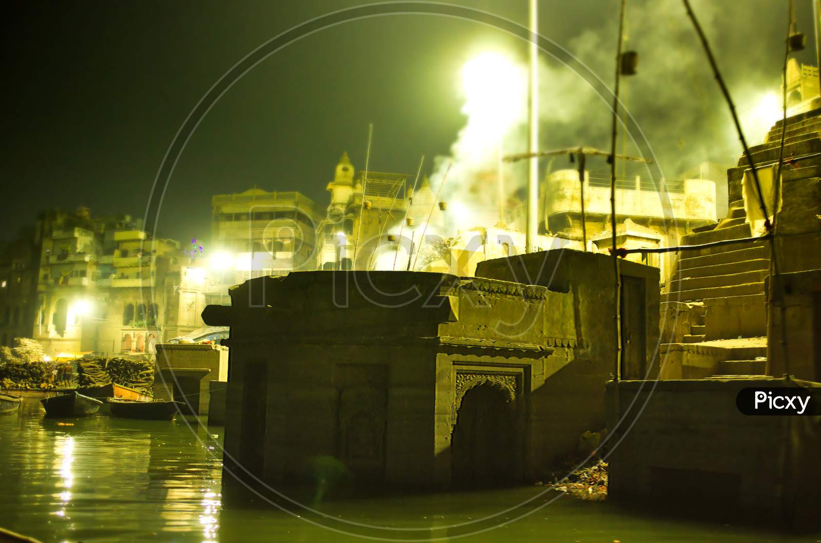 Smokes Spreading From Fire Due To Cremation Next To Ganga River In Varanasi, Located In The State Of Uttar Pradesh, India