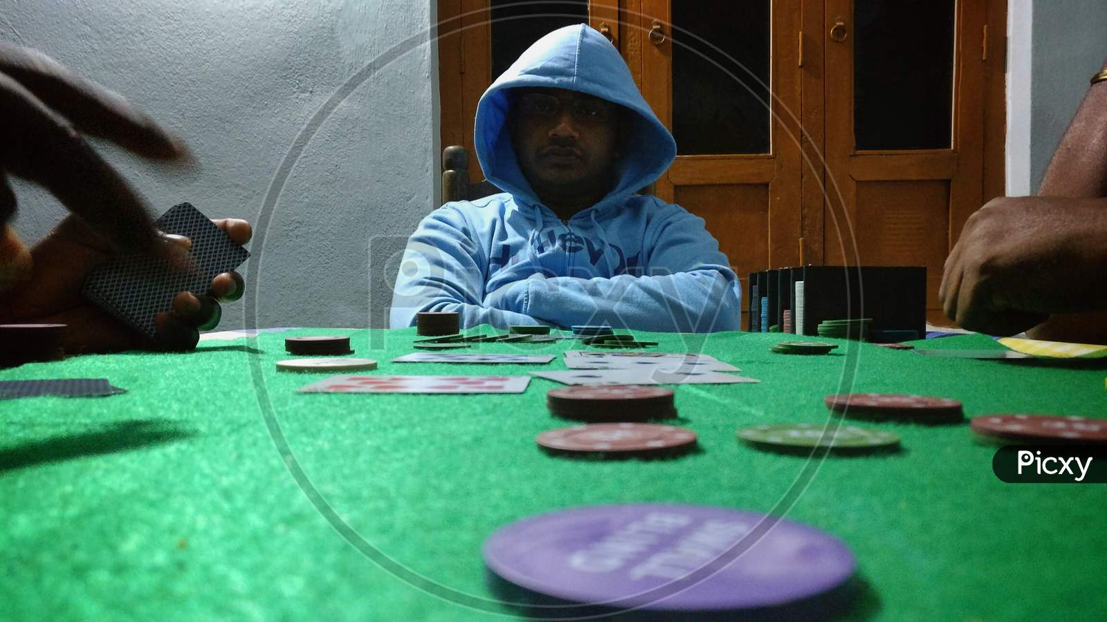 Men Dealer Or Croupier Shuffles Poker Cards In A Casino On The Background Of A Table, Chips,. Concept Of Poker Game, Game Business, India.