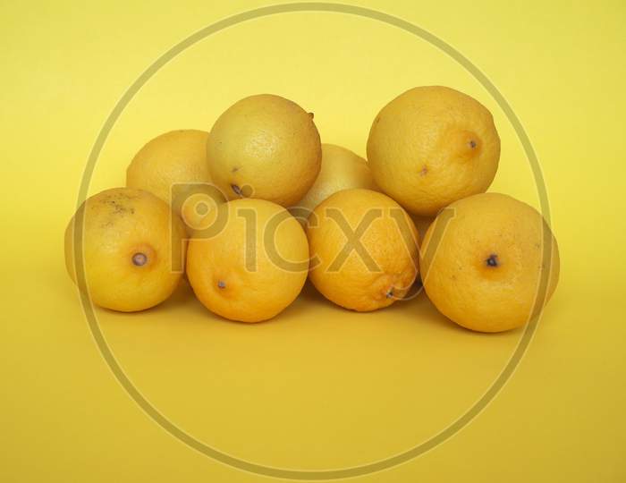 Lemon Fruits Over Yellow Background