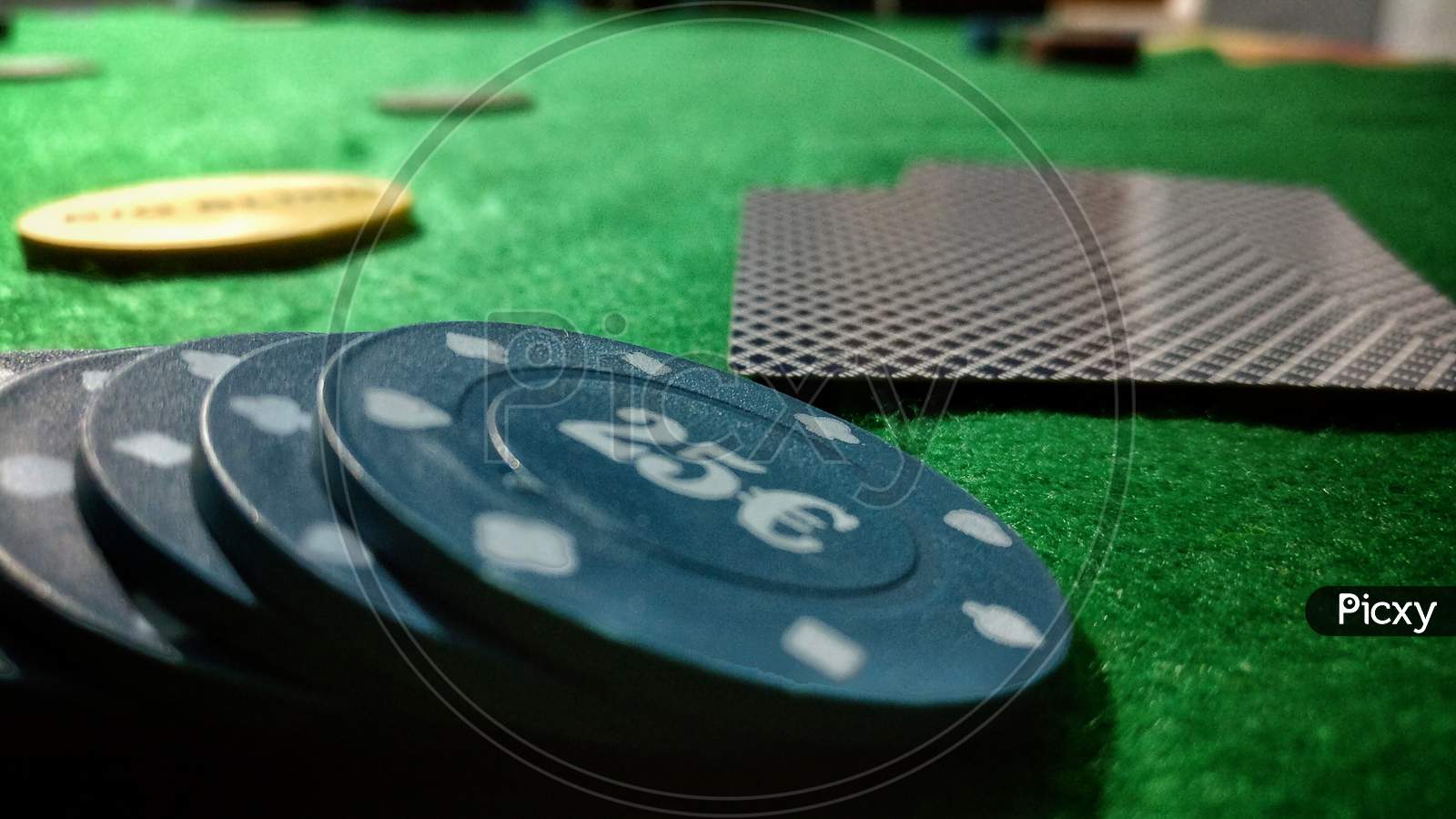 Black Poker Chips Lie On A Bright Green Canvas Concept Of Gambling And Casino
