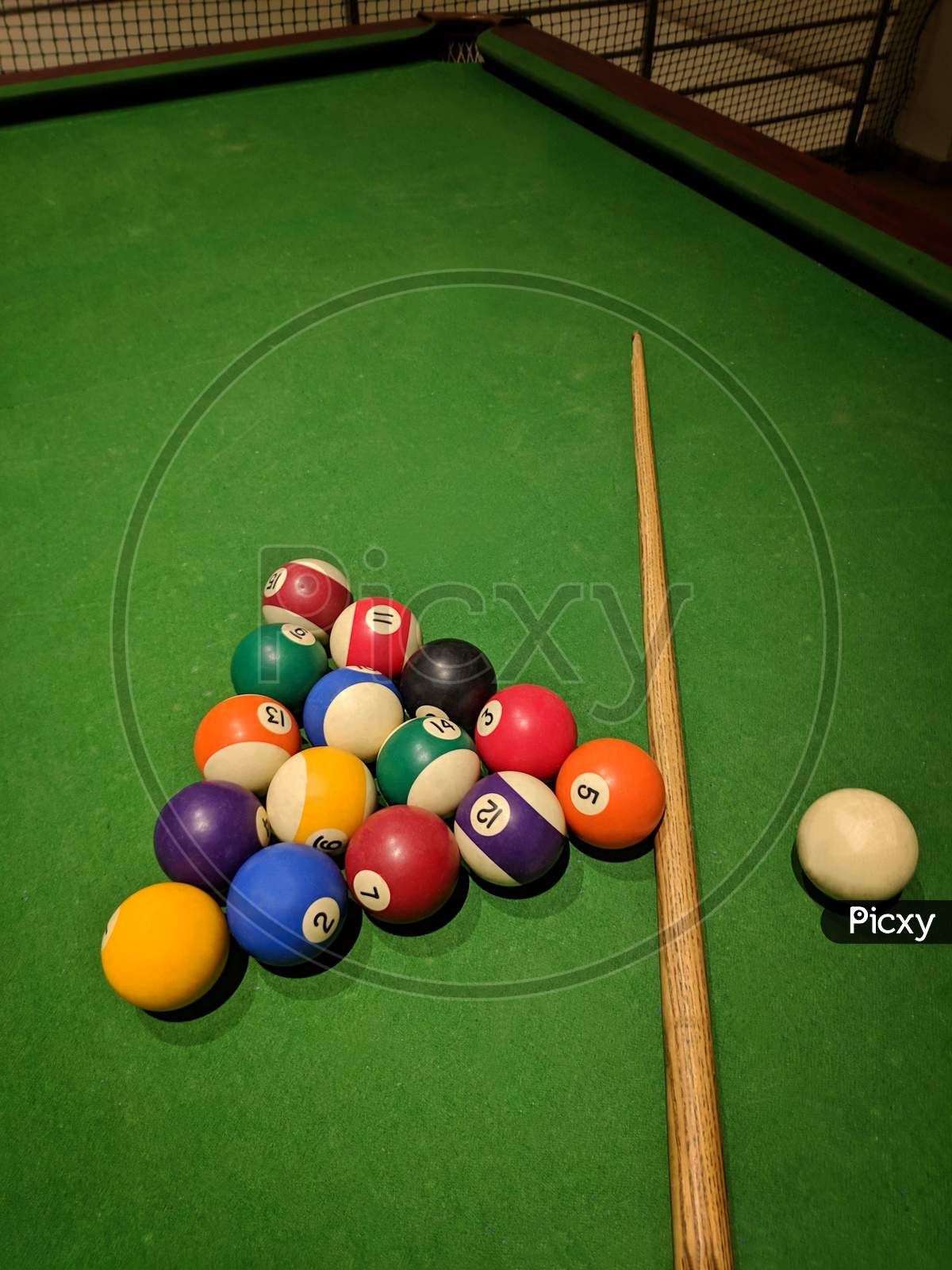 Billiard Balls And Cue Stick On Green Table. Pool Game, Colored Balls For Playing Snooker On A Green Cloth Of A Billiard Table,India.