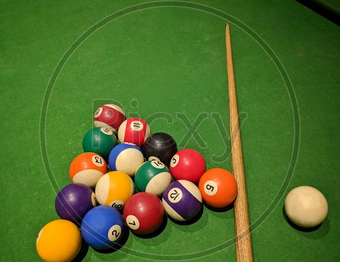 Billiard Balls And Cue Stick On Green Table. Pool Game, Colored Balls For Playing Snooker On A Green Cloth Of A Billiard Table,India.